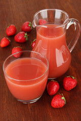 Delicious strawberry juice on table close-up