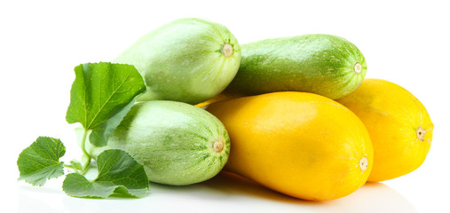 Raw yellow and green zucchini with leaves, isolated on white