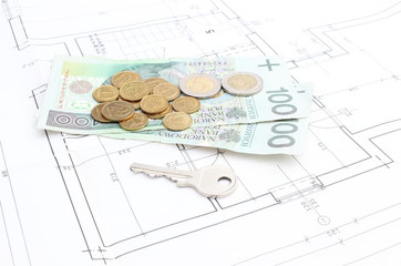 Money and silver key lying on the housing plan