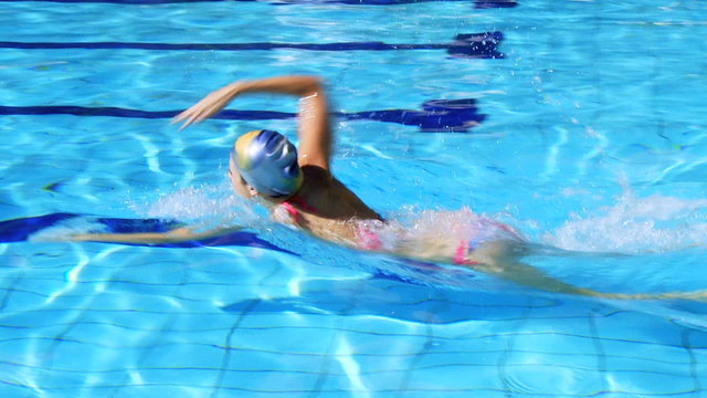 Beautiful female swimmer training in swimming pool