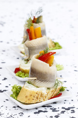 Pickled herring rolls with vegetables