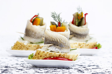 Pickled herring rolls with vegetables