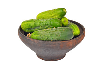 Cucumber gherkin in clay bowl, isolated on white background