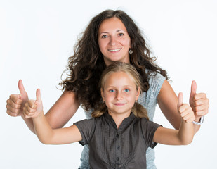 Smiling girl with mother showing ok sign