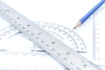 aluminium rulers and half circle scale blue pencil education geometry tool on white background.