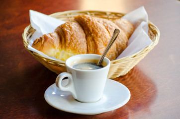Cup of espresso with croissant