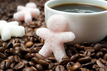 sugar in the form of a little man and a cup of coffee, close-up
