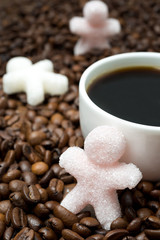 sugar in the form of a little man and a cup of coffee, vertical