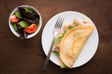 Cheese and ham crepe with salad