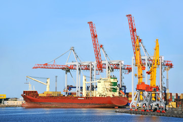 Container stack and ship under crane bridge