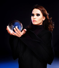 Naklejka premium Young woman with crystal ball.