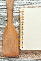Wooden spatula, notebook and ribbon