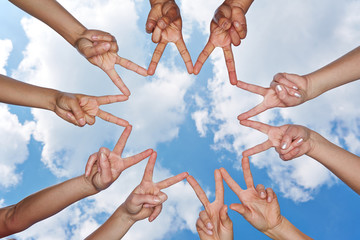 Hands showing star under sky