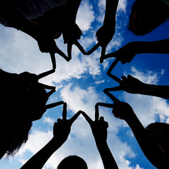 Silhouette of hands forming star network