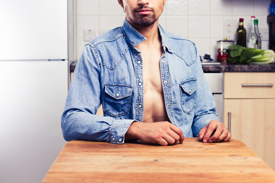 Sexy young man in kitchen