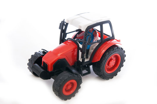 Tractor red toy on white