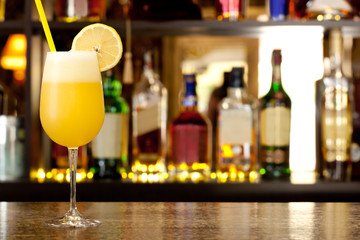 Yellow cocktail with a lemon