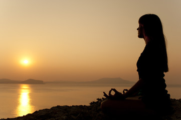 yoga pose silhouette at sunrise