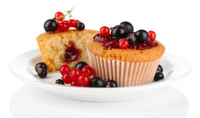 Tasty muffins with berries isolated on white