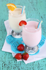 Delicious milk shakes with orange and strawberries