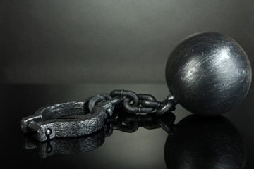 Ball and chain on grey background