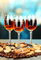 Glasses of liquors with almonds and coffee grains,