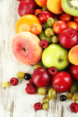 Assortment of juicy fruits, on wooden background