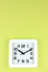 Office clock on color wall background