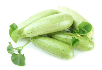 Raw zucchini with leaves, isolated on white