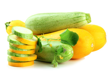 Sliced and whole raw zucchini, isolated on white
