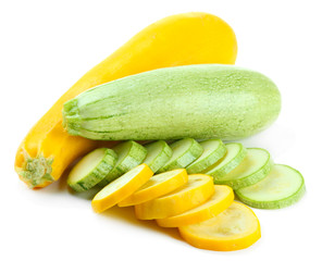 Sliced and whole raw zucchini, isolated on white