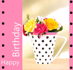 Beautiful bouquet of bright flowers in color mug,