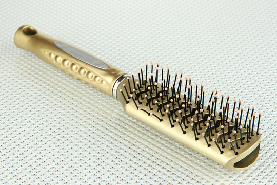 Hairbrush on color background