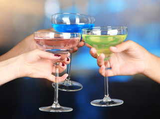 Cocktails in hands in nightclub