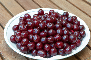 Fresh cherries on white plate