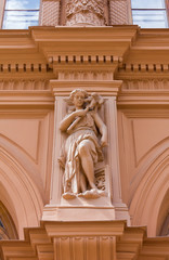 Close-up on Historic Building's Facade with Feminine Statue