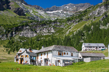 Fototapeta na wymiar Small moutain village, white houses in Italian Alps