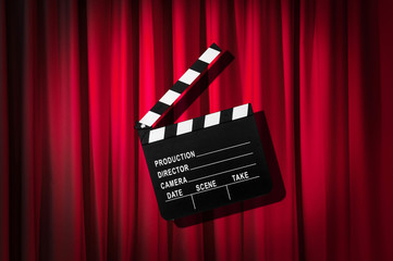 Movie clapper board against curtain