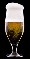 Frosty glass of light beer on black background