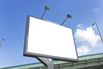 Billboard at highway over blue sky