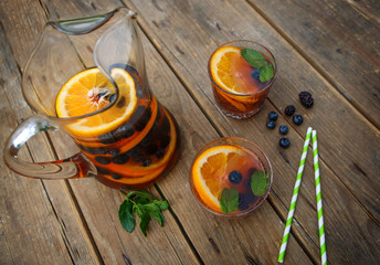 Berry sangria - summer cocktail, decorated with berries, orange