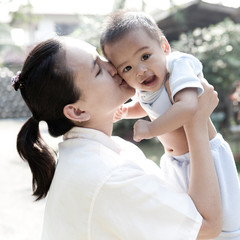 Fototapeta premium Asian mom kiss baby