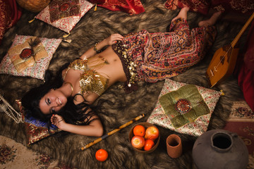 Beautiful belly dancer in the arabic harem interior