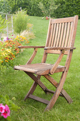 Wooden chair in the lawn on a sunny day in Switzerland