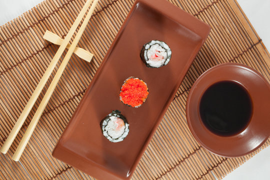 Sushi menu with Soy Saouce and Chopsticks, on traditional wood b