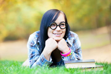 Teen girl with notebook in the park.