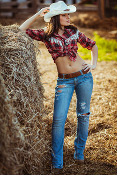 cowgirl model posing on farm