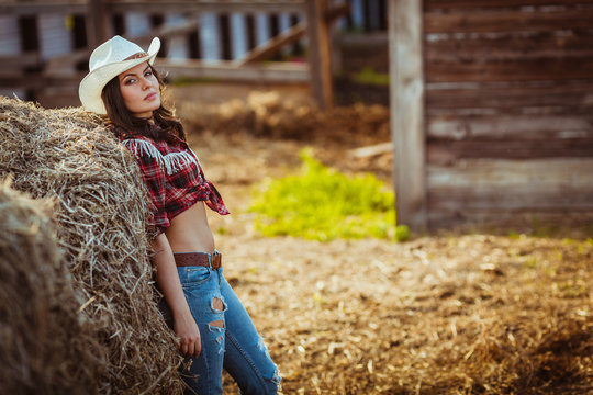 cowgirl model posing on farm