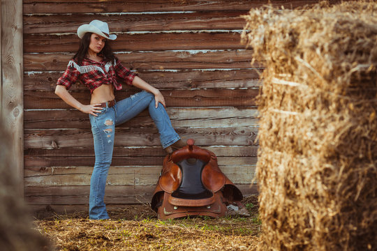 cowgirl model posing on farm