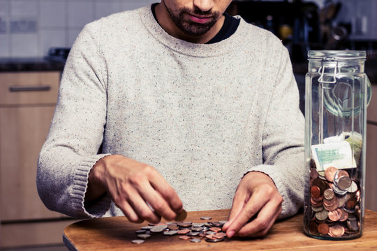 Man counting his money in kitchen
